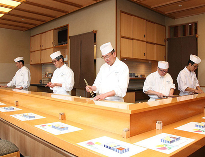 Five to six chefs at the counter